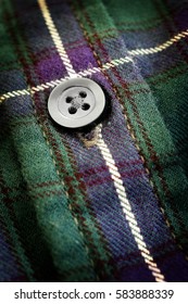 Closeup Of Button On Plaid Flannel Shirt