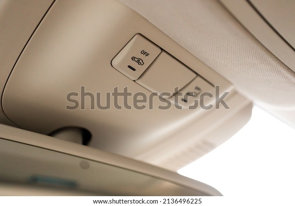 Closeup of cabin lights switch\
in car, light control panel inside a car interior. For reading\
etc.