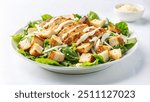 A close-up of a Caesar salad with grilled chicken, croutons, and creamy dressing.