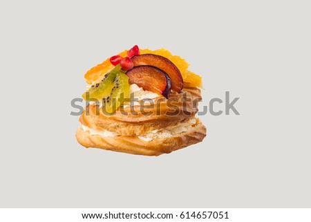 Closeup of cake with fresh fruits on gray background.