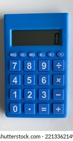 Closeup Of Calculator, Blue Color With White Keypad And Numbers, In Portrait. Screen At Zero. No Logos.