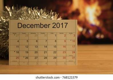 Close-up: Calendar of the month December 2017 is on a wooden table in a room with festive atmosphere. Concept: Christmas and New Year's holidays. - Shutterstock ID 768121579