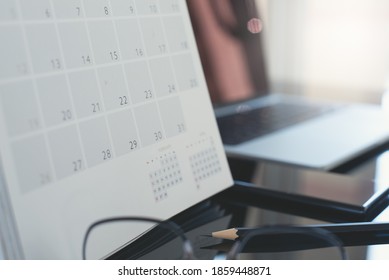 Closeup Of Calendar Timetable Event Planner, Work Schedule On Table In Modern Office With Pencil, Mobile Phone, Laptop Computer And Nobody, Business Plan With Blurred Background Copy Space