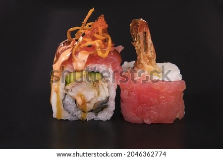 A closeup of Californian tuna rolls on a black background
