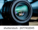 Close-up camera lens,Photo Camera or Video lens close-up on black background, objective, concept of photographer camera man job, looking for a photographer, 