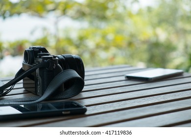 Closeup camera and mobile with side view on table