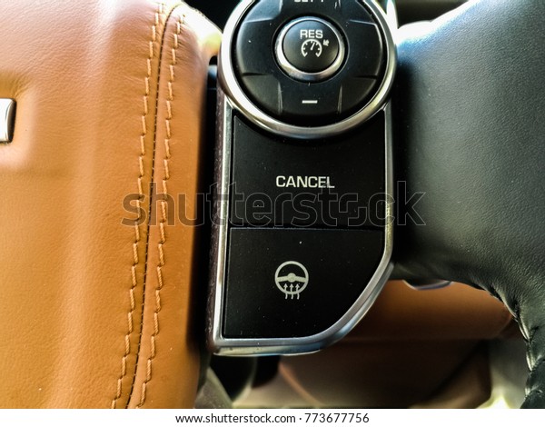 closeup of cancel button for the cruise control system\
of an exotic vehicle 