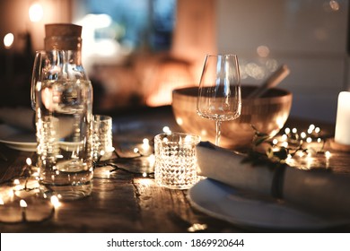 Closeup Of A Candlelit Dining Table Set Up With Glasses And Tableware For An Evening Dinner Party