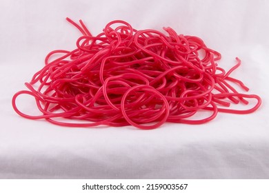 A Closeup Of A Candy Pile Of Delicious Red Strawberry Laces