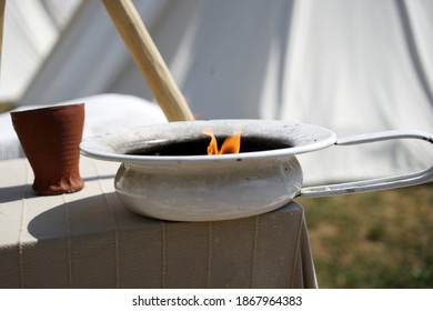 A Closeup Of A Canning Pot Reused As A Candle Holder On The Table