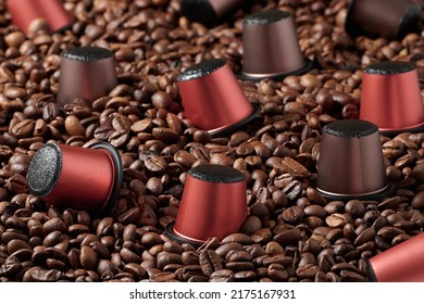 Closeup capsules with coffee of different varieties, for a capsule coffee machine. Against the background of roasted coffee beans. - Shutterstock ID 2175167931