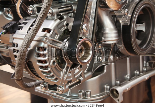 Closeup of a car alternator, component of car\
electrical system