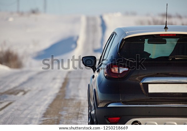 Close-up of a car\
behind a snowy road in\
winter