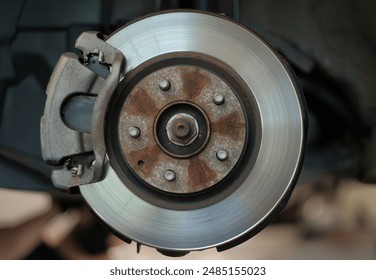 Close-Up of Car Brake Disc and Caliper in Auto Repair Shop Vehicle Maintenance - Powered by Shutterstock