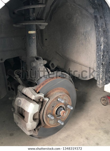 Close-up Car brake disc without wheels. Car brake part\
at garage.  