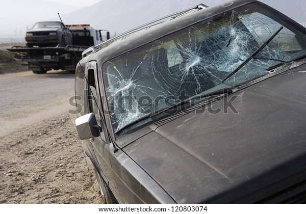 Closeup of car with broken\
windshield