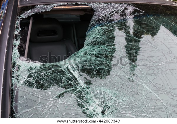 Closeup of car with broken\
windshield