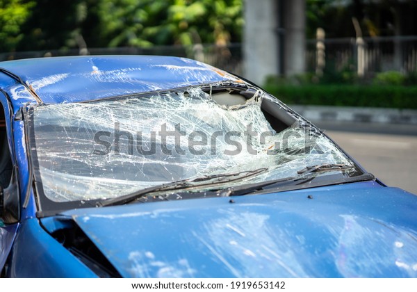 Closeup of car with broken windshield, Terrible\
dangerous car after a fatal accident. Broken windshield. A broken\
car with broken glass. Сar\
hazard.