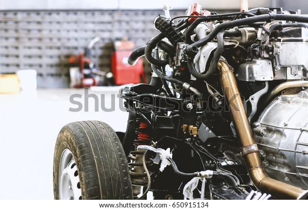 closeup car chassis with engine. soft-focus\
and over light in the\
background