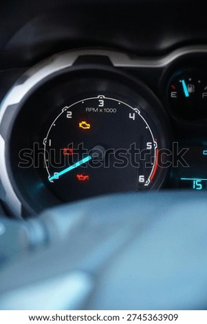 Close-up of a car dashboard with multiple warning lights illuminated, including check engine, battery, and oil pressure icons, signifying mechanical trouble.