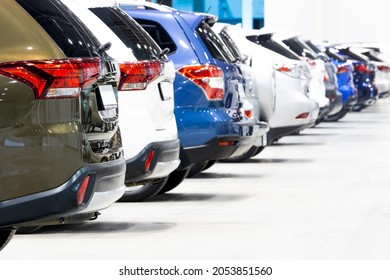 close-up of a car dealership rows of urban crossovers for sale, rear view
