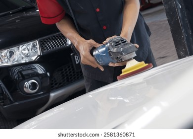 Close-Up of a Car Detailer Using a Buffer Machine for Paint Correction