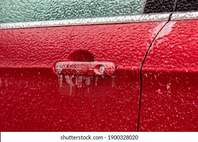 Closeup Of Car Door Handle And Lock Covered In Ice During Winter Storm. Concept Of Winter Driving Preparedness And Safety