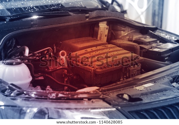 Close-up, car engine with red light, concept\
of engine overheating