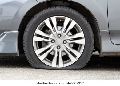 Closeup Car Flat Tire On The Road.