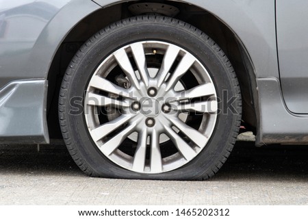 Closeup car flat tire on the road.