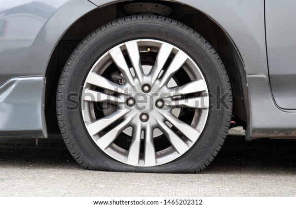 Closeup car flat tire on the\
road.
