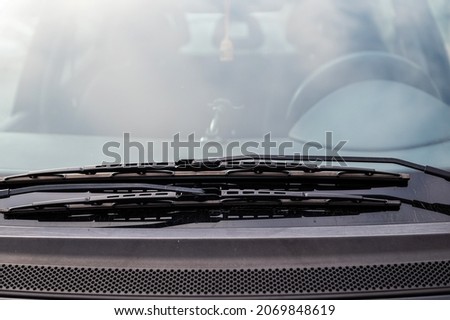 closeup of car front windshield and windshield wipers, selective focus