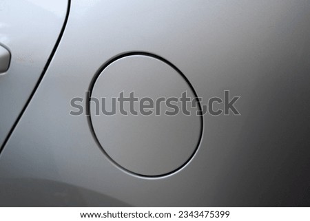 Close-up of a car gas cap on a silver kia rio 