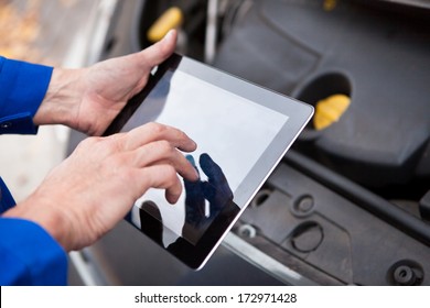 Close-up Of A Car Mechanic Using Digital Tablet - Powered by Shutterstock