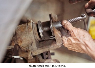 Closeup of a car mechanic's hand. screw special tool for replacing brake pads in Brake Calipers. car repair, suspension parts, garage repair. car brake system.
