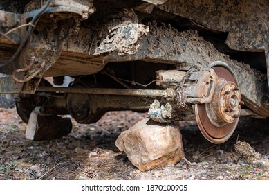 Close-up Car With Missing Wheels Stolen Car Wheel Pollution And Crime Problem Conversation Vintage Rusted Detail Discarded In Autumn Forest In Bulgaria, Eastern Europe