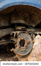 Close-up Car With Missing Wheels Stolen Car Wheel Pollution And Crime Problem Conversation Vintage Rusted Detail Discarded In Autumn Forest In Bulgaria, Eastern Europe