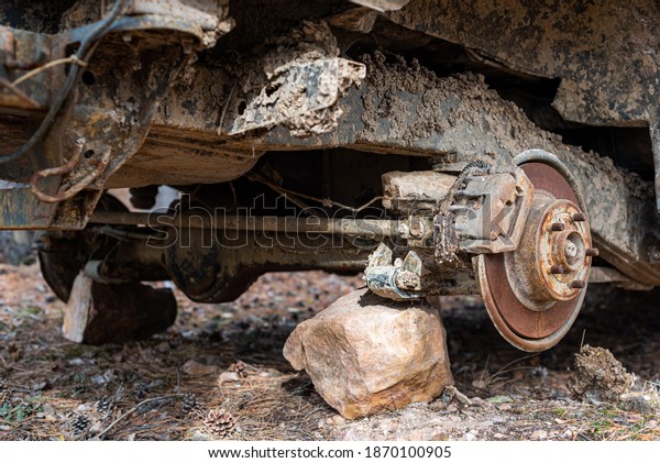 Close-up car with\
missing wheels stolen car wheel pollution and crime problem\
conversation vintage rusted detail discarded in autumn forest in\
Bulgaria, Eastern\
Europe