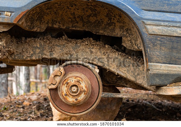Close-up car with\
missing wheels stolen car wheel pollution and crime problem\
conversation vintage rusted detail discarded in autumn forest in\
Bulgaria, Eastern\
Europe