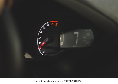 A close-up of a car panel with a speedometer