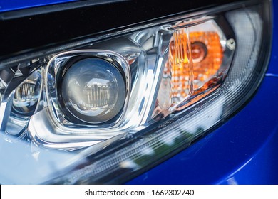 A close-up of a car projector headlight