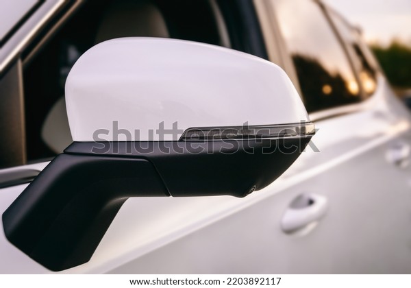 close-up car side mirror with LED turn signal,\
modern car, modern car safety\
systems