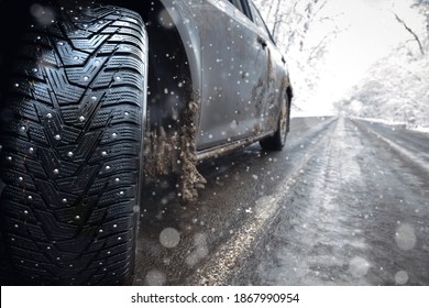 Closeup of car spikes  tires in winter on the road covered with snow. ice on the road
