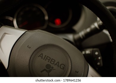 Close-up Of Car Steering Wheel With Large Airbag Sign. Car Whistle On Airbag Safety Sticker. Beware Of Passive Safety Devices In The Vehicle.