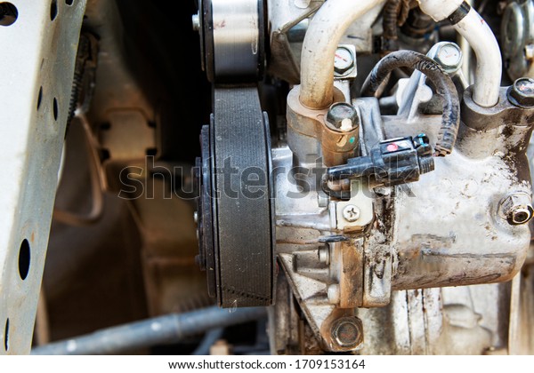 closeup car timing belt or engine belt in dirty\
engine room