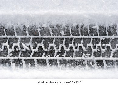 Close-up Car Tire Tracks In The Snow