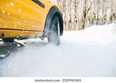 Close-up of a car wheel skidding on a frozen, icy road. - Powered by Shutterstock