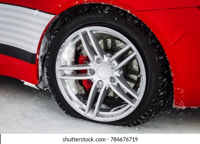 Close-up Car Wheel With Tire Flat And Air Leak From Accident. On The Winter  Road