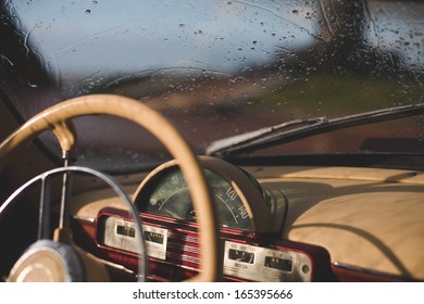 Close-up of a car wheel of the Volga and the windshield in the rain