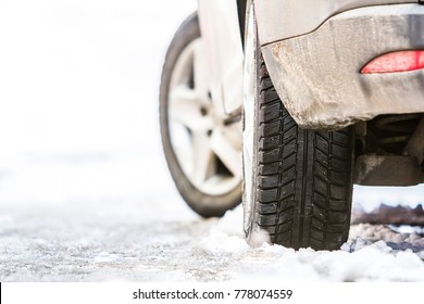 Close-up Of Car Wheel In Winter Tire On Snowy Road